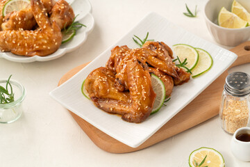 Honey Lemon Glazed Chicken Wings with Sesame and Lime.