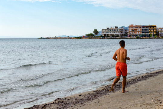 Man jogging along the beach in the morning