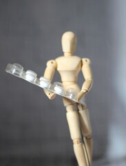 Wooden mannequin with pills medicine photo help care 