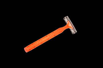 Disposable razor isolated on black background, close-up.