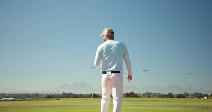 Gripping baseball glove, senior male pitcher initiating wind-up on mound, celebrating strikeout