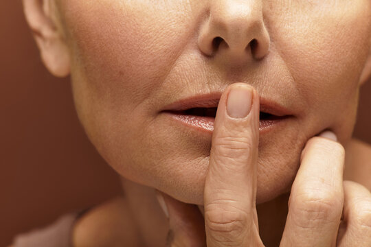 Elegant senior woman with a thoughtful expression in a warm, intimate setting