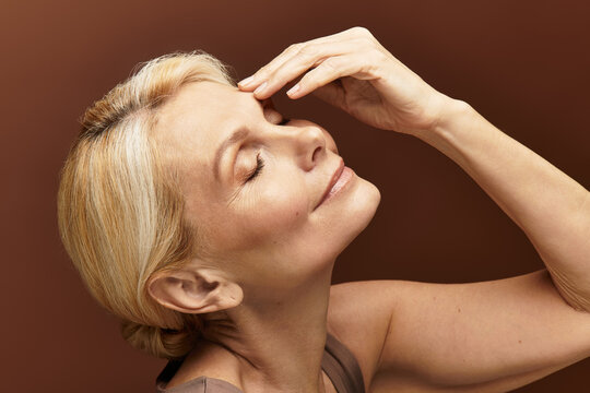 Capturing the beauty of a senior woman embracing her elegance and grace in a serene moment