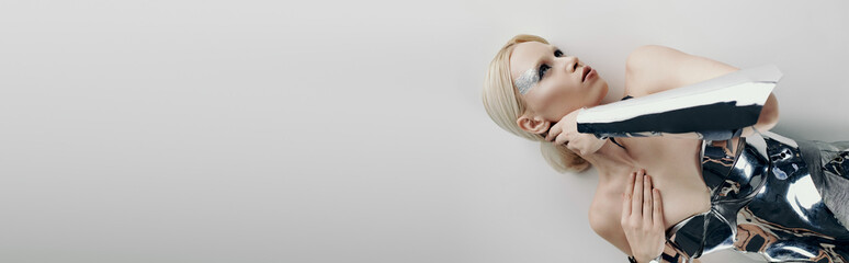 Futuristic fashion showcasing a young blonde woman in a modern studio setting