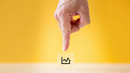 Index Finger Pointing at a Stock Market Chart Icon on Yellow Background Investment Analysis and Financial Growth Prediction for Business and Economy