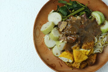 Rujak cingur. javanese vegetable salad with rice cake and cow mouth. with peanut sauce.