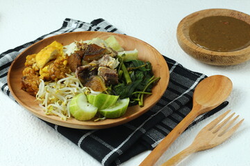 Rujak cingur. javanese vegetable salad with rice cake and cow mouth. with peanut sauce.