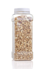 Granola with nuts in plastic bottle isolated on white