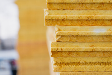 Fiberglass insulation boards stacked thermal building material for renovation construction housing energy saving efficiency industrial architecture infrastructure protective system closeup