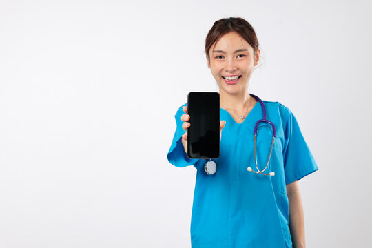 Asian woman show blank screen on mobile phone application as positive nurse in healthcare, service displays health treatment for dedicated work, confident nurse, headshot isolated white background - Powered by Adobe