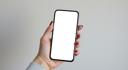 A hand holds a smartphone with a blank white screen against a clean, light grey background. This versatile and minimalist mockup is suitable for a wide range of app and website presentations.