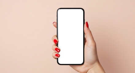 A woman's hand with red nail polish holds a smartphone with a blank white screen. This stylish mockup on a two-tone pink and beige background is perfect for beauty or fashion apps.