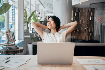 Portrait of smiling asian woman making break, working stress relief on laptop computer in office....
