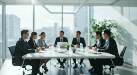 Fototapeta premium Blurred corporate business meeting in modern office boardroom with professional team discussing strategy around conference table