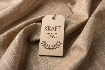 Kraft paper tag with text and laurel wreath on fabric