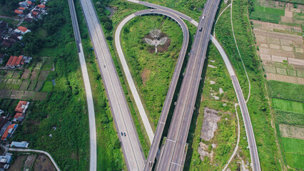 Obraz premium Scenic Aerial View of a Sumo Toll Road and Green Field at Surabaya, East Java Indonesia