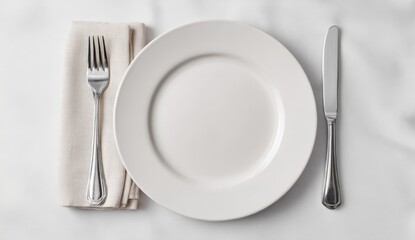 Empty white plate, fork, knife, and napkin on a table