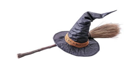 • A spooky Halloween witch’s hat and broomstick, isolated on white background in HD 