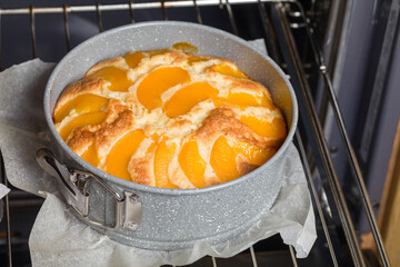Pie with peaches is baked in a oven