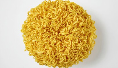A close-up, top-down view of a round mound of dried, yellow instant noodles