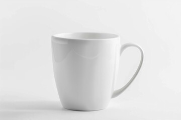 Obraz premium Plain white ceramic mug placed on a white surface with a sleek and minimalistic design for daily use
