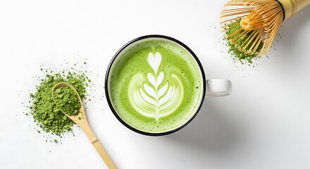Top view of a hot matcha green tea latte with beautiful foam art, surrounded by powder and a whisk