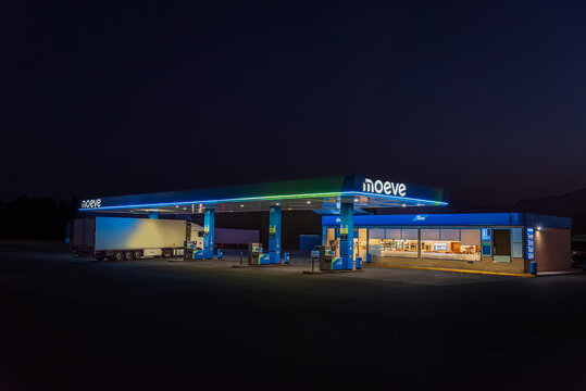 Hellin,Albacete,Spain,8/6/2025; Moeve energy company service station lit at night