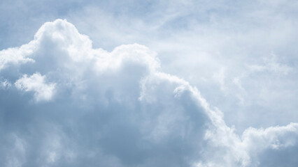 A detailed close-up shot of large, fluffy cumulus clouds on a bright day, filling the frame