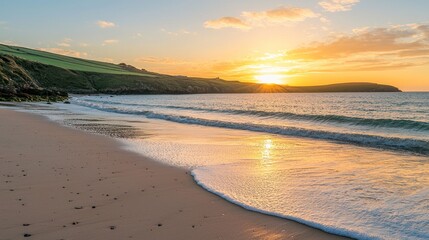 Obraz premium A calm, peaceful beach at sunset, with soft waves lapping against the shore and a warm, golden glow.