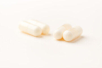 Creatine capsules on paper background. Soft focus. Close up. Copy space.	