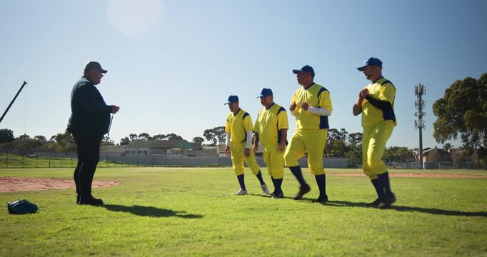 Coach signaling baseball players in uniforms performing stretches on field with timing device