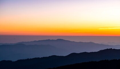 Obraz premium Layered mountain ranges at sunrise.