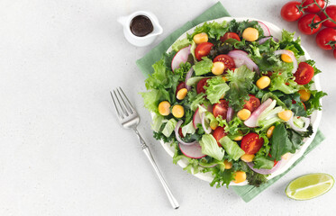 Summer green salad with tomatoes, redish and lupin beans on white background. Top view. Vegan food