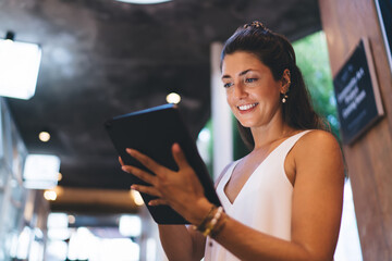 Focused young man working on tablet using stylus in quiet setting. Technology empowers independent creatives to control their time, tools, and environment freely.