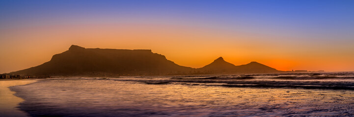 Panorama of Sunset over Table Mountain, Cape Town and Table Bay viewed from Blauberg Strand