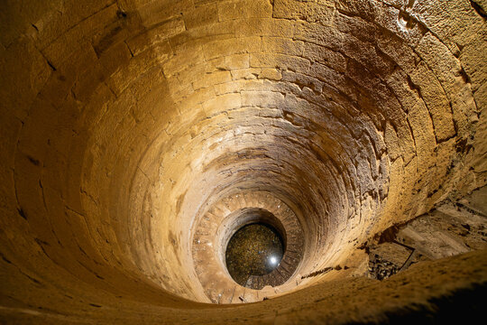 Looking down into the ancient Nilometer at the Temple of Kom Ombo, a structure used to measure the water level of the Nile River.
