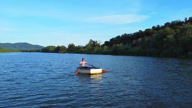 fisherman in boat get fishing nets from river, Silhouette of fisherman,a dip net for fishing at Pakpra village, jijel Algeria. fishing boat traditional and net . Fisherman on the traditional boat.