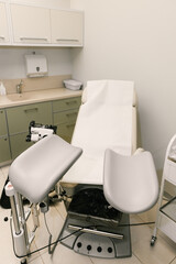 Gynecological chair in medical examination room