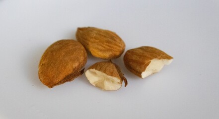 Close-up of a pile of raw, in-shell almonds of the Laureanne variety, freshly harvested. Detail of the almond harvest in an organic farming field in Badajoz, Extremadura, Spain