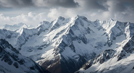 Panoramic view of snow-covered mountain peaks and dark clouds
