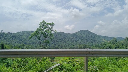 landscape view of mountain and field under sky