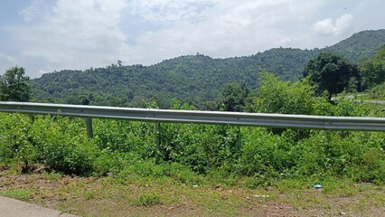 landscape view of mountain and field under sky