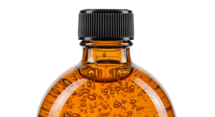 Clear orange liquid inside a plastic bottle with black cap showcasing bubbles, suitable for beverage or ingredient related stock imagery