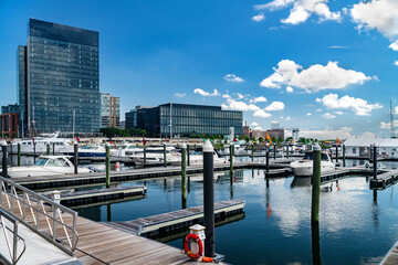 Baltimore city waterfront with boats, yachts, marina docks and modern high-rise office buildings.