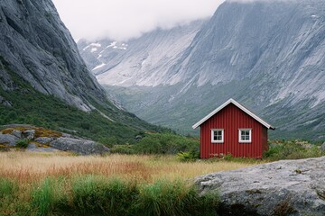 Obraz premium Red wooden Scandinavian cabin nestled in a valley surrounded by majestic mountains and lush greenery