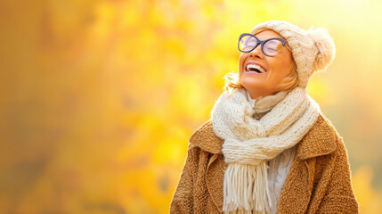 A joyful woman in warm winter attire smiles brightly against a backdrop of autumn leaves, radiating happiness and warmth.