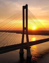 Obraz premium Cable-stayed bridge at sunset over a river