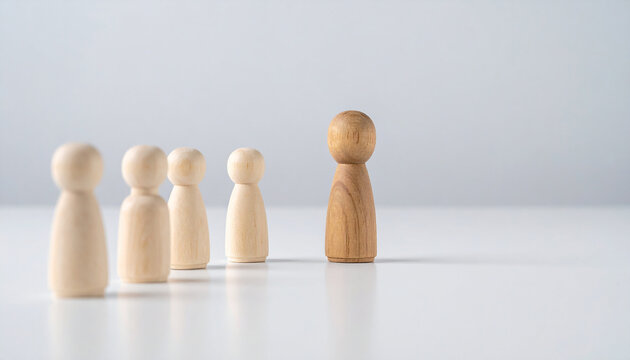 One wooden figure stepping forward while others follow, movement concept. Community, leadership - Powered by Adobe