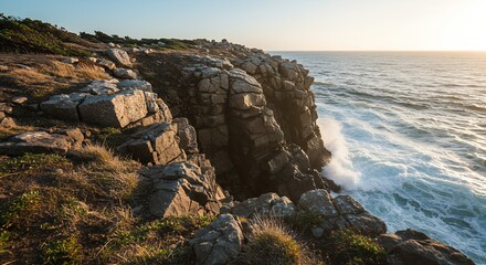 Dramatic coastal cliffs with layered rock formations and powerful white waves crashing against the shoreline at sunset.