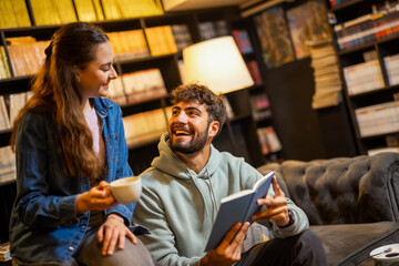 Students reading together in library cafe